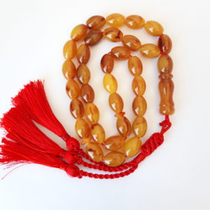 Deep honey natural amber sand, red handmade tassel